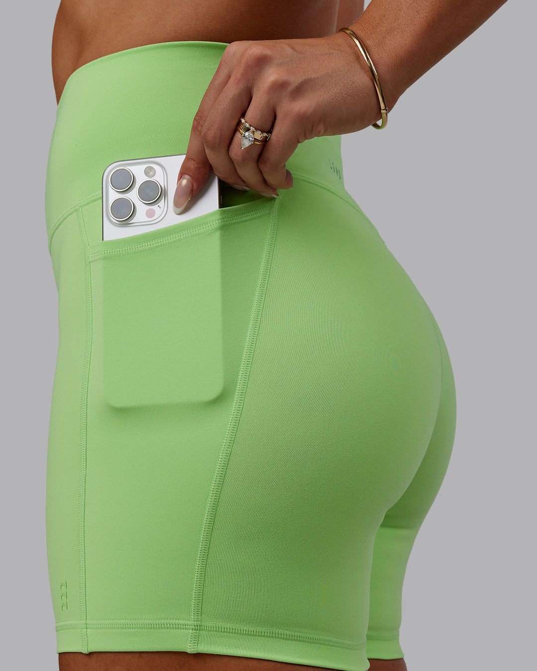 Woman wearing Bree Masters Fusion Mid Short Tights with Pockets - Pastel Lime