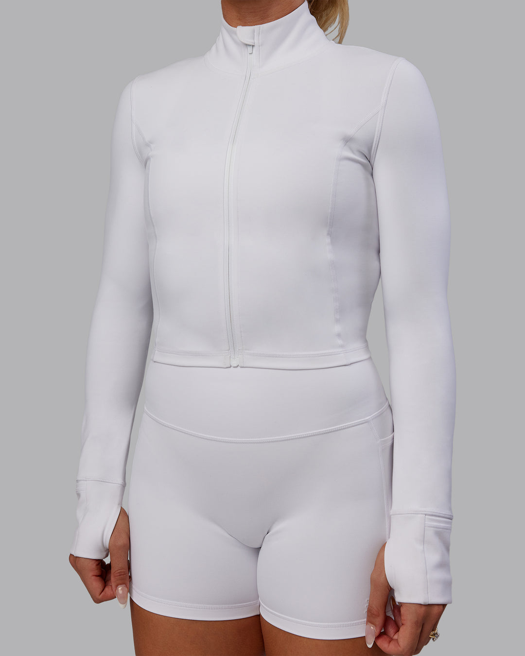 Woman wearing Bree Masters Stride Zip Through Cropped Jacket - White