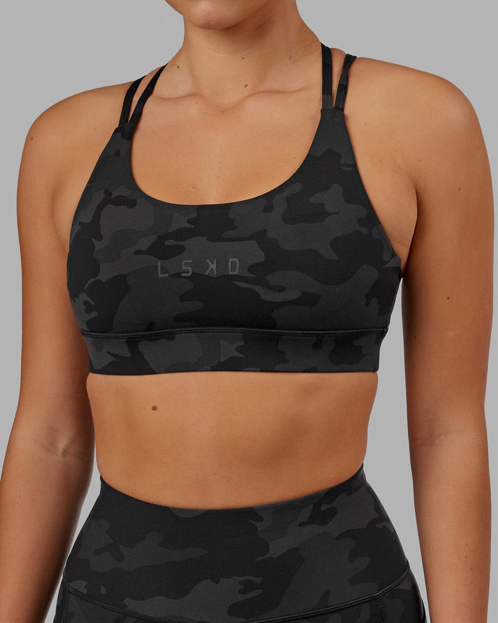 Woman wearing Bridge Sports Bra - Black Camo
