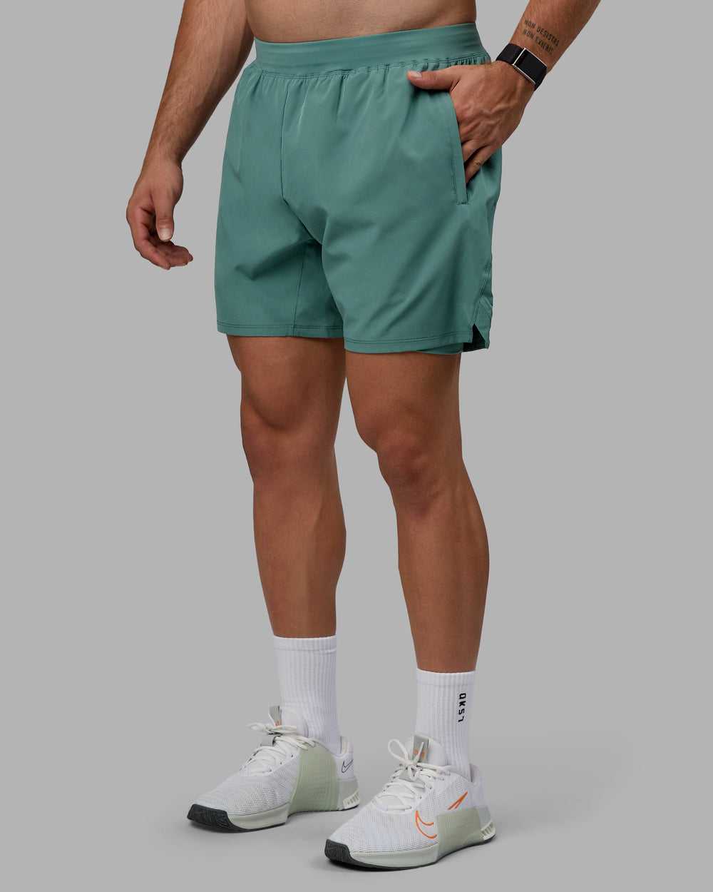 Man wearing Challenger 6" Lined Performance Shorts - Sagebrush