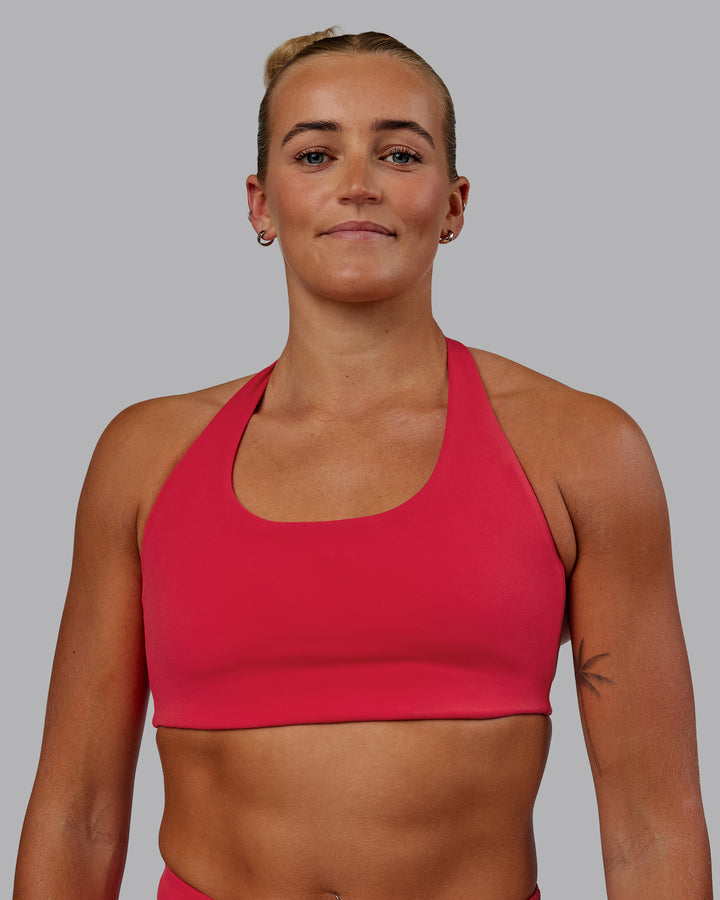 Woman wearing Challenger Sports Bra - Scarlet
