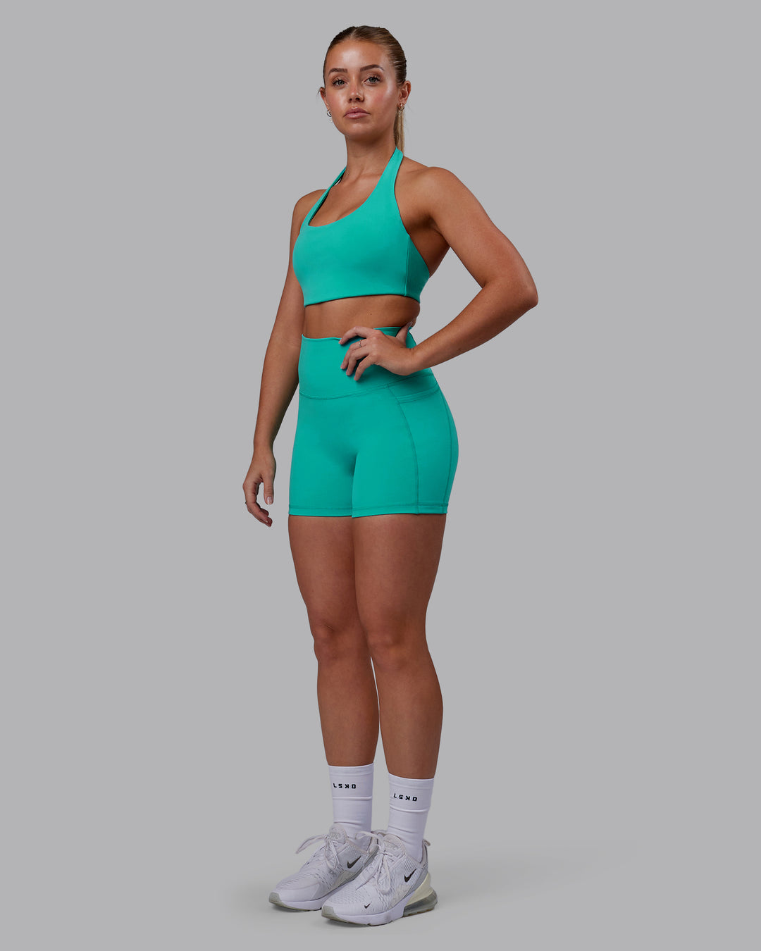 Woman wearing Challenger Sports Bra - Turquoise Tide