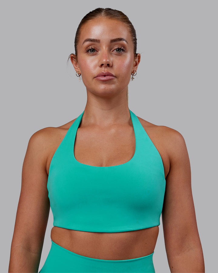 Woman wearing Challenger Sports Bra - Turquoise Tide
