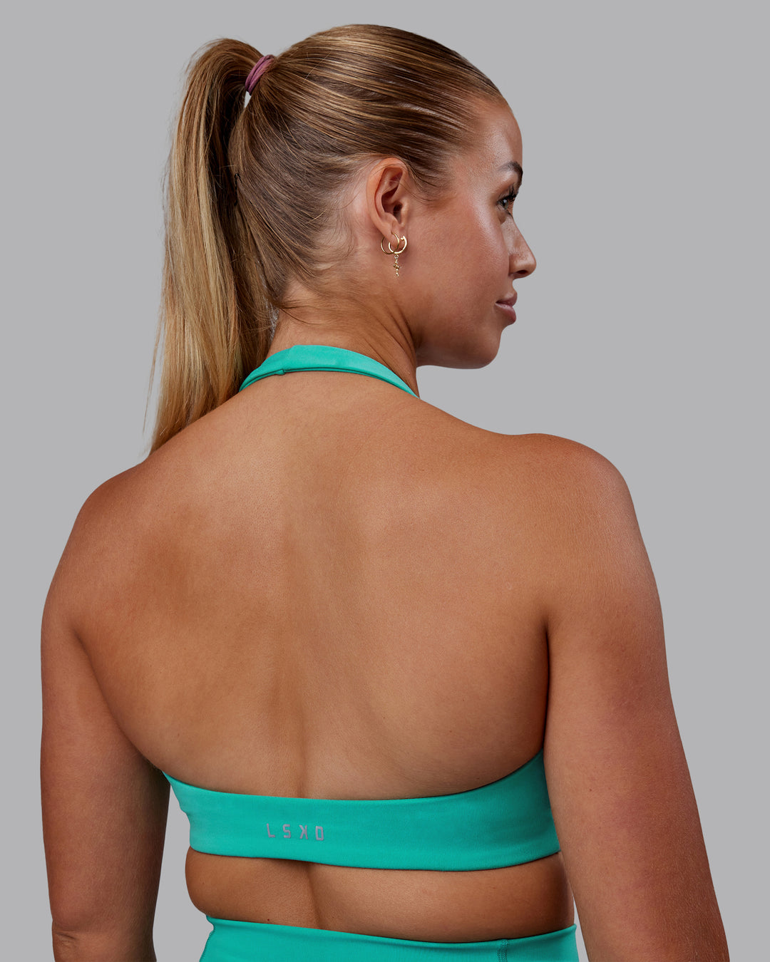 Woman wearing Challenger Sports Bra - Turquoise Tide