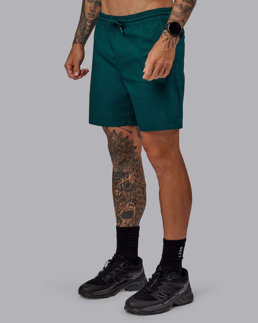 Man wearing Daily 7" Shorts - Dark Moss