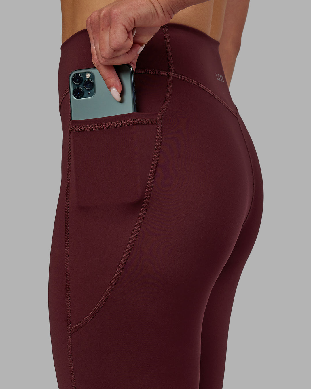 Woman wearing Elite 7/8 Length Leggings - Dark Cherry