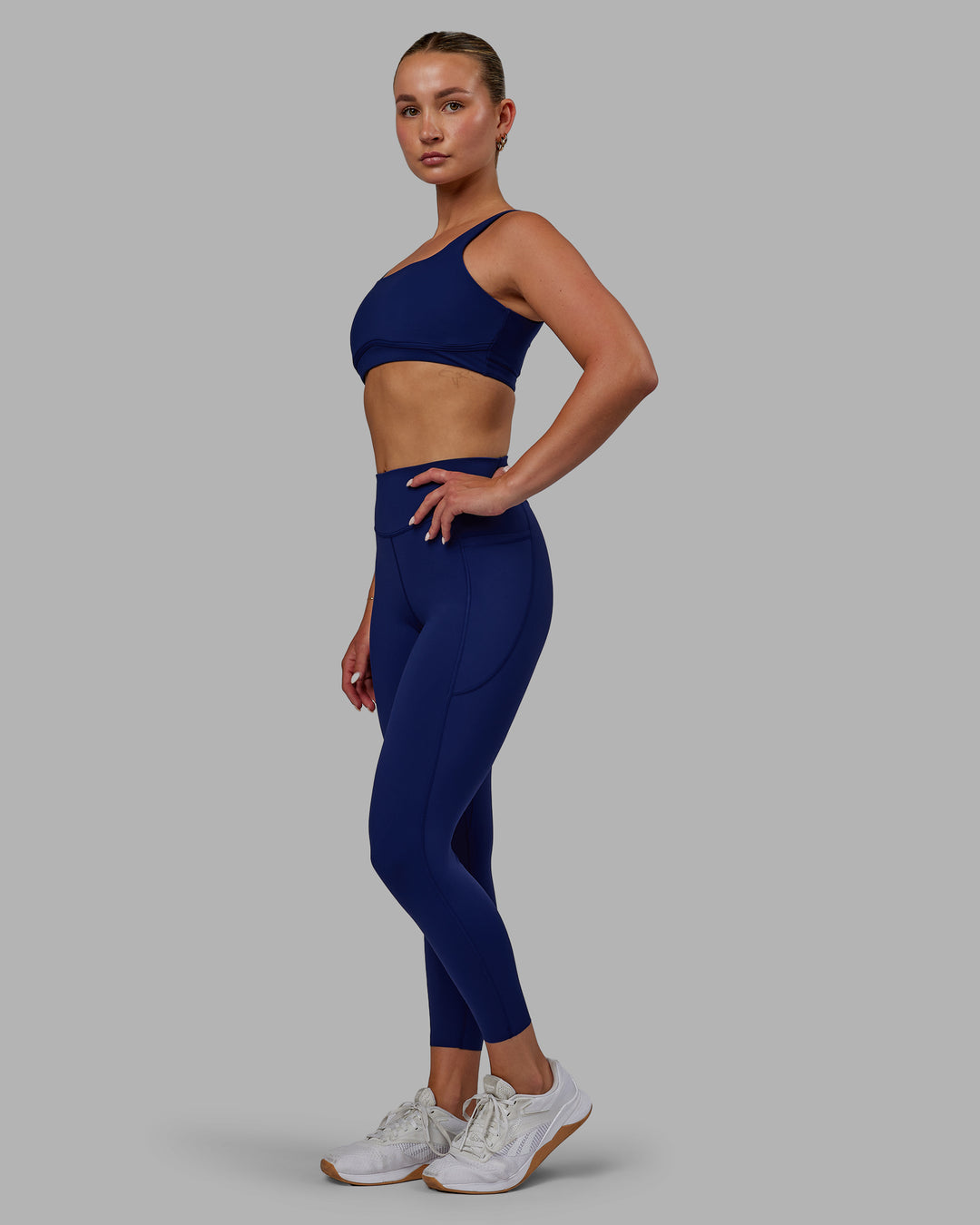 Woman wearing Elite 7/8 Length Leggings - Midnight Blue