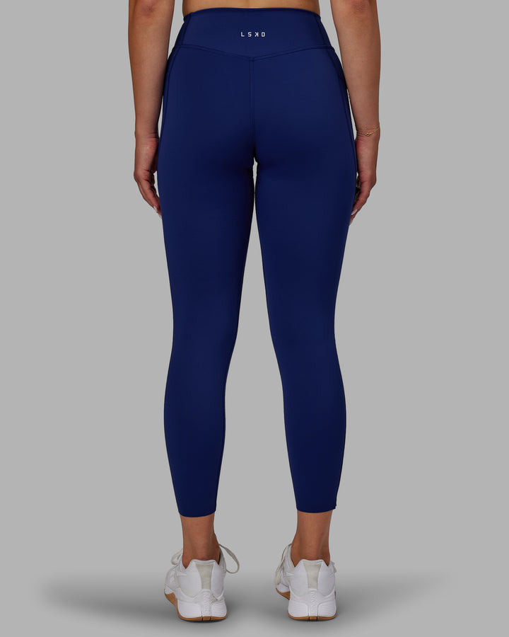 Woman wearing Elite 7/8 Length Leggings - Midnight Blue
