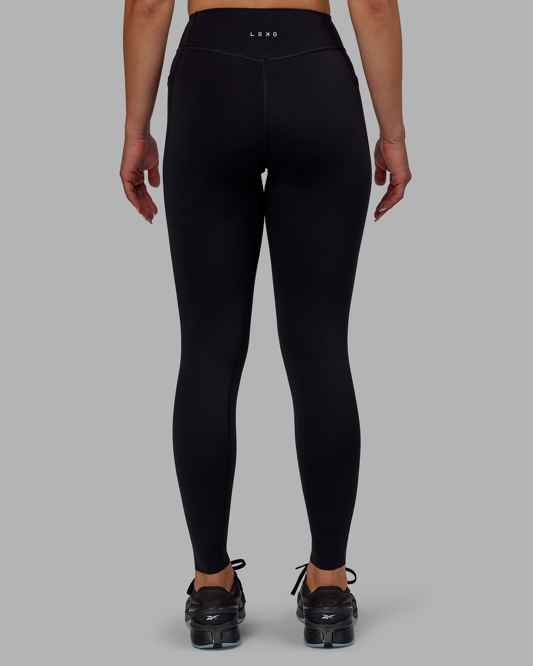 Woman wearing Elite Full Length Leggings - Black