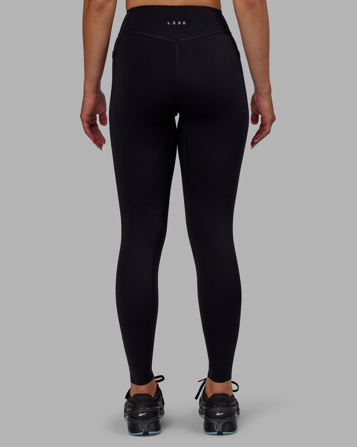 Woman wearing Elite Full Length Leggings - Black
