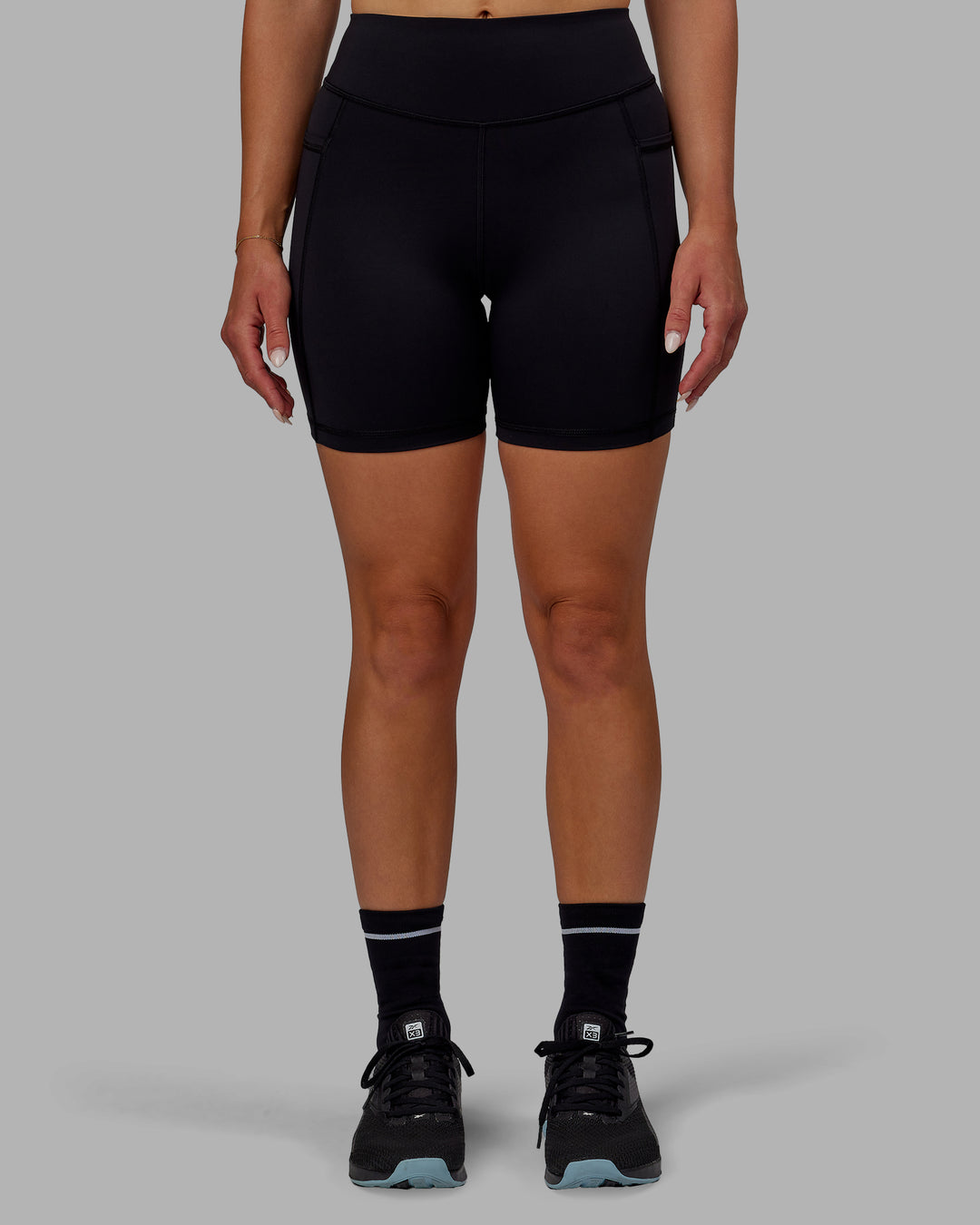 Woman wearing Elite Mid-Length Shorts - Black