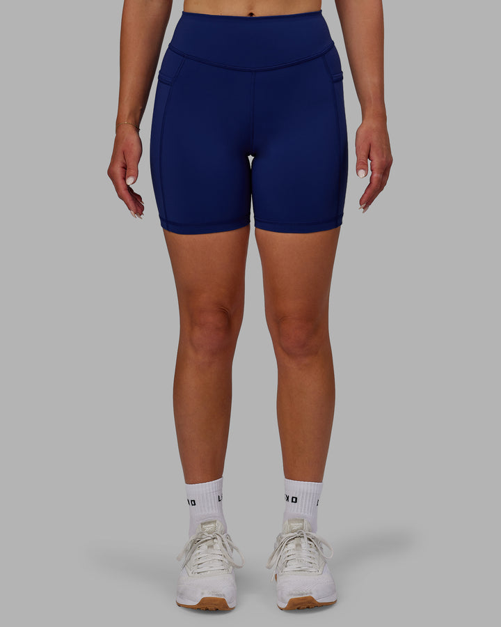 Woman wearing Elite Mid-Length Shorts - Midnight Blue
