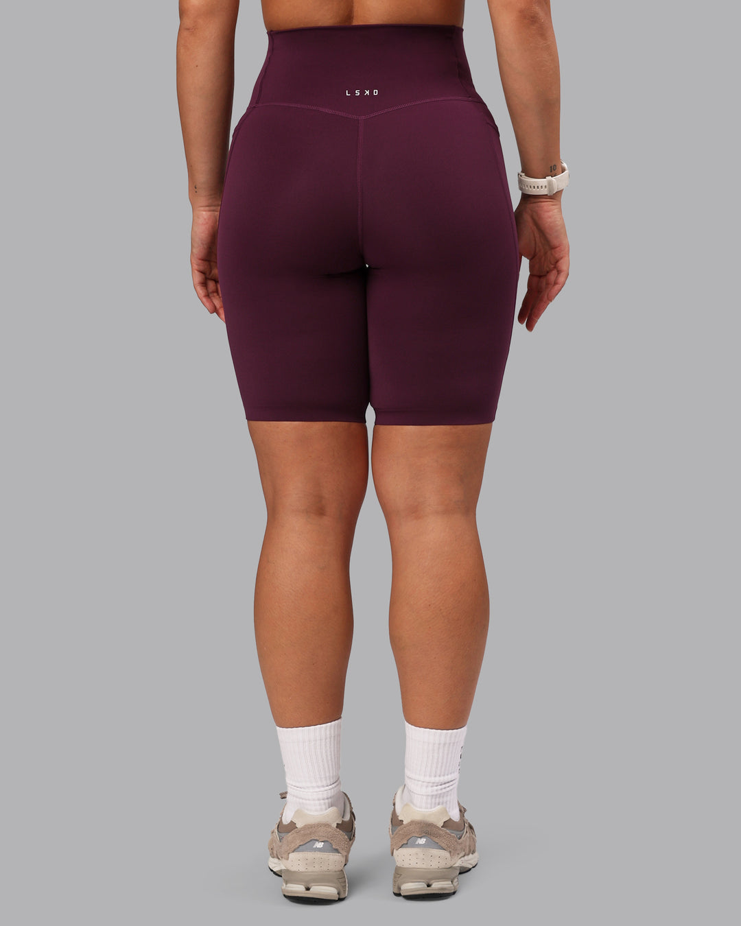 Woman wearing Elixir Bike Shorts With Pockets - Cherry Lacquer