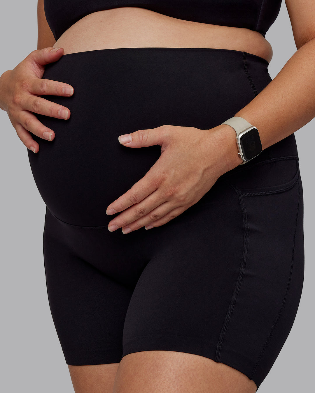 Woman wearing Elixir Maternity Mid Short Tights With Pockets - Black