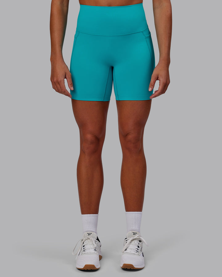 Woman wearing Elixir Mid Short Tights with Pockets - Blue Bird
