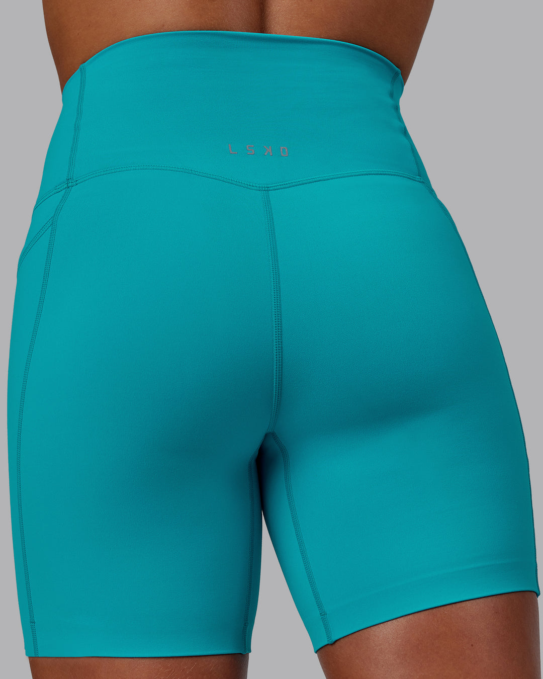 Woman wearing Elixir Mid Short Tights with Pockets - Blue Bird