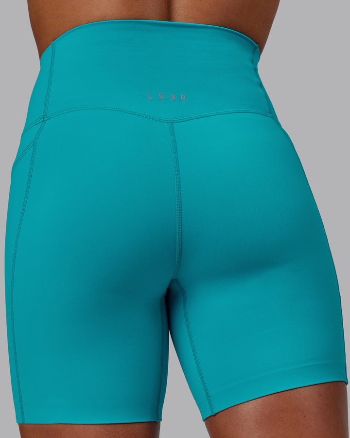 Woman wearing Elixir Mid Short Tights with Pockets - Blue Bird
