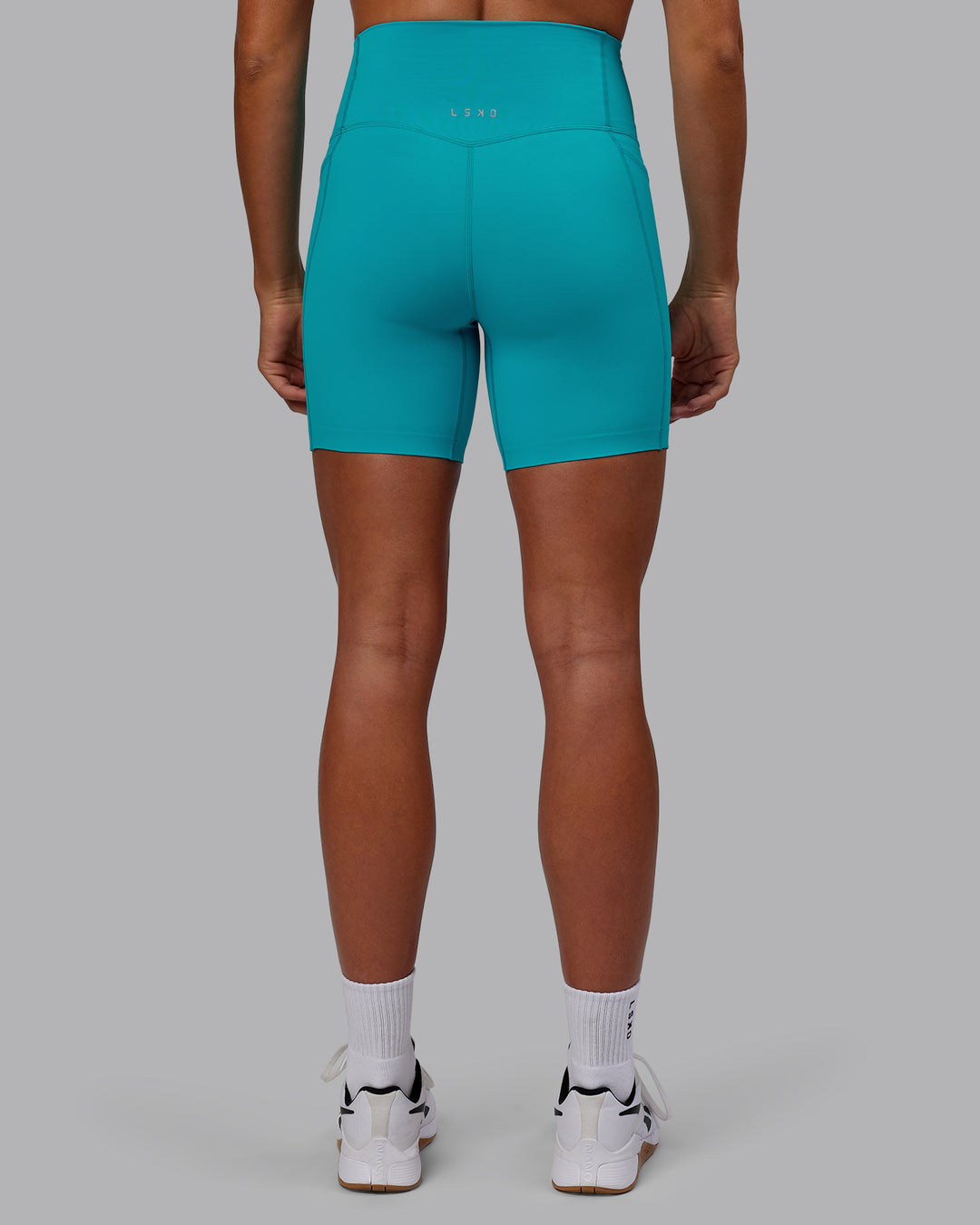 Woman wearing Elixir Mid Short Tights with Pockets - Blue Bird