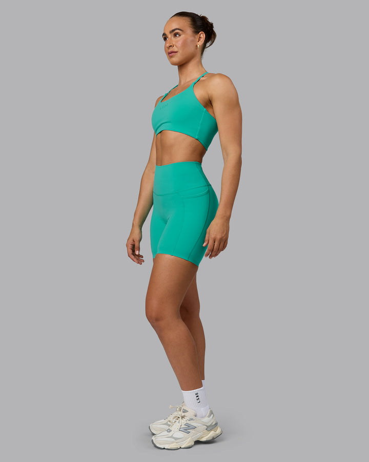 Woman wearing Elixir Mid Short Tights with Pockets - Atlantis
