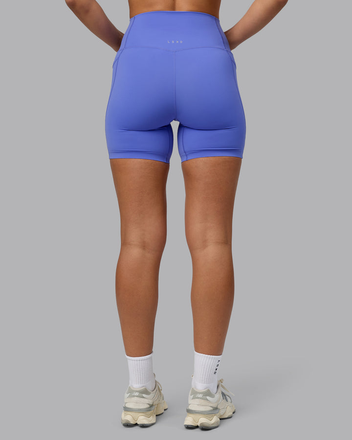 Woman wearing Elixir Mid Short Tights with Pockets - Baja Blue
