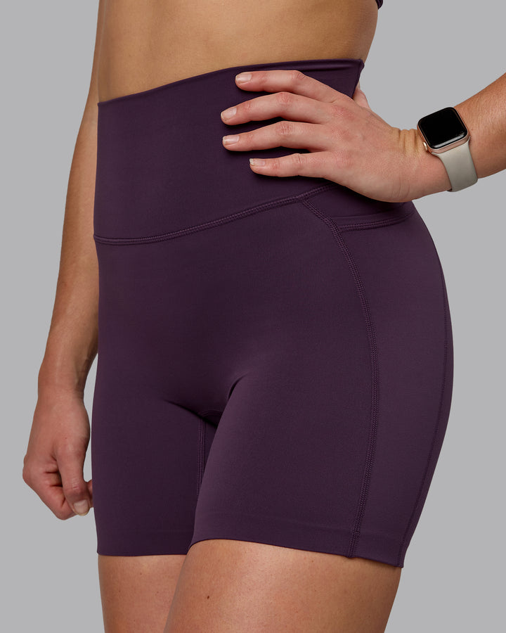 Woman wearing Elixir Mid Short Tights With Pockets - Midnight Plum
