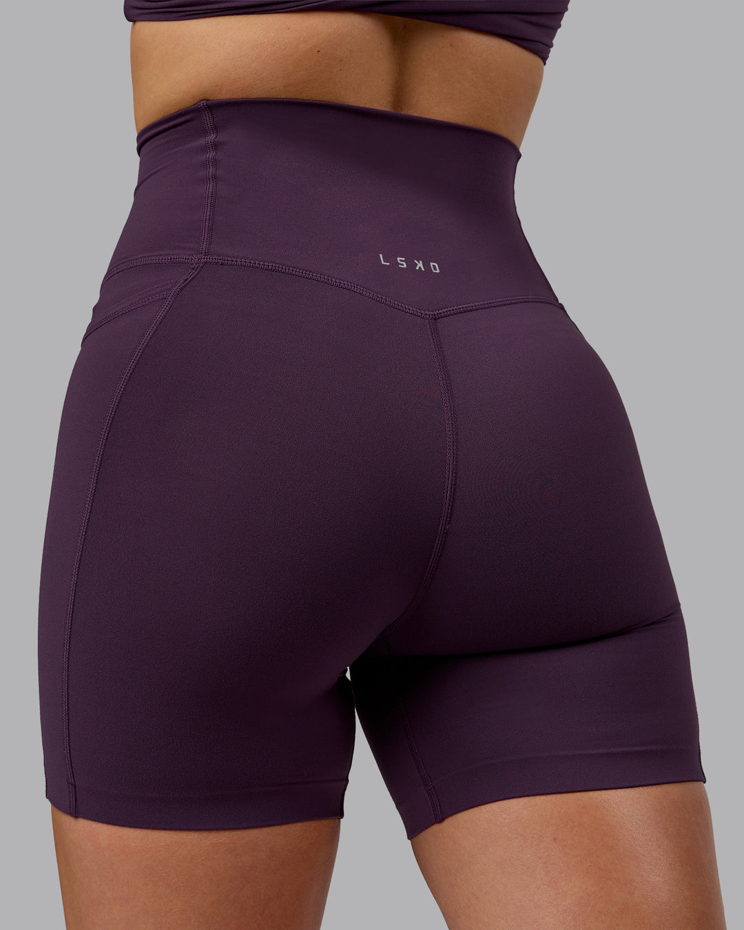 Woman wearing Elixir Mid Short Tights With Pockets - Midnight Plum