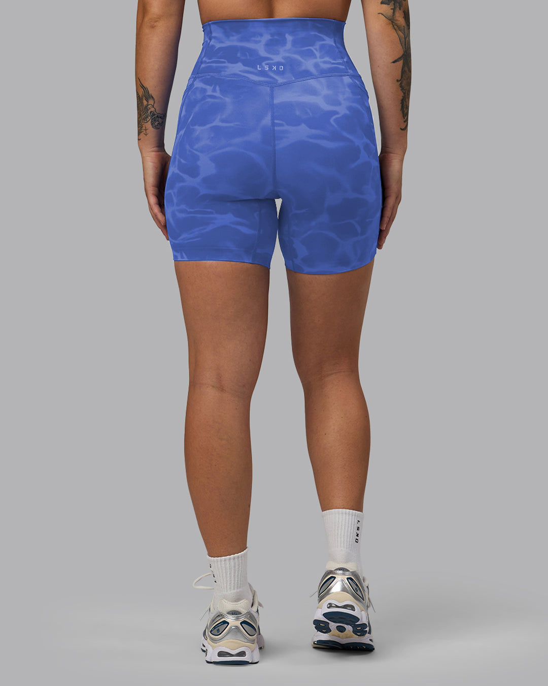 Woman wearing Elixir Mid Short Tights with Pockets - Tranquil-Power Cobalt