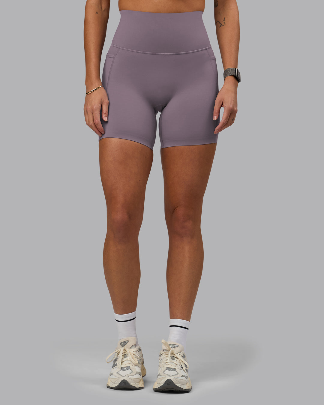 Woman wearing Elixir Mid Short Tights with Pockets - Purple Sage