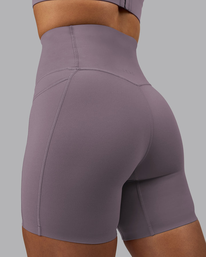 Woman wearing Elixir Mid Short Tights with Pockets - Purple Sage
