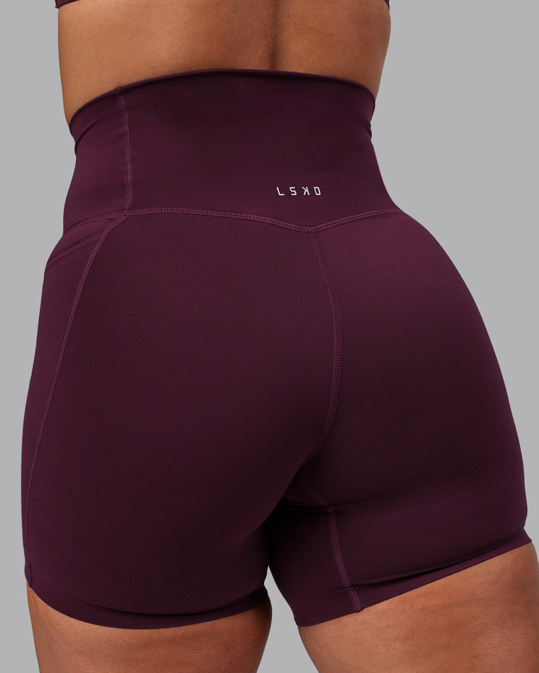 Woman wearing Elixir Mid Short Tights with Pockets - Cherry Lacquer