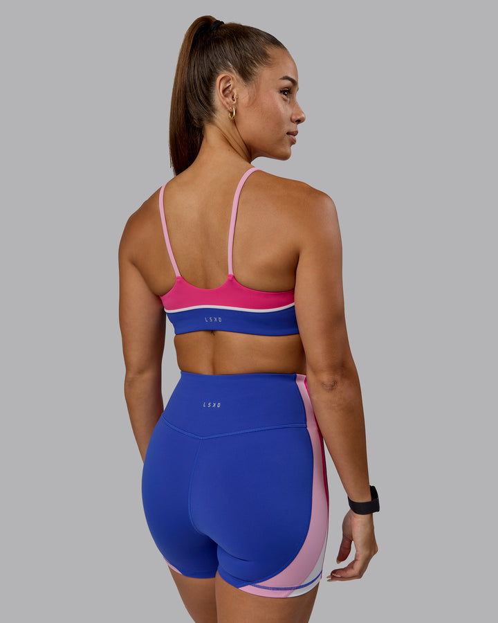 Woman wearing Embrace Sports Bra - Power Cobalt-Fuchsia Pink
