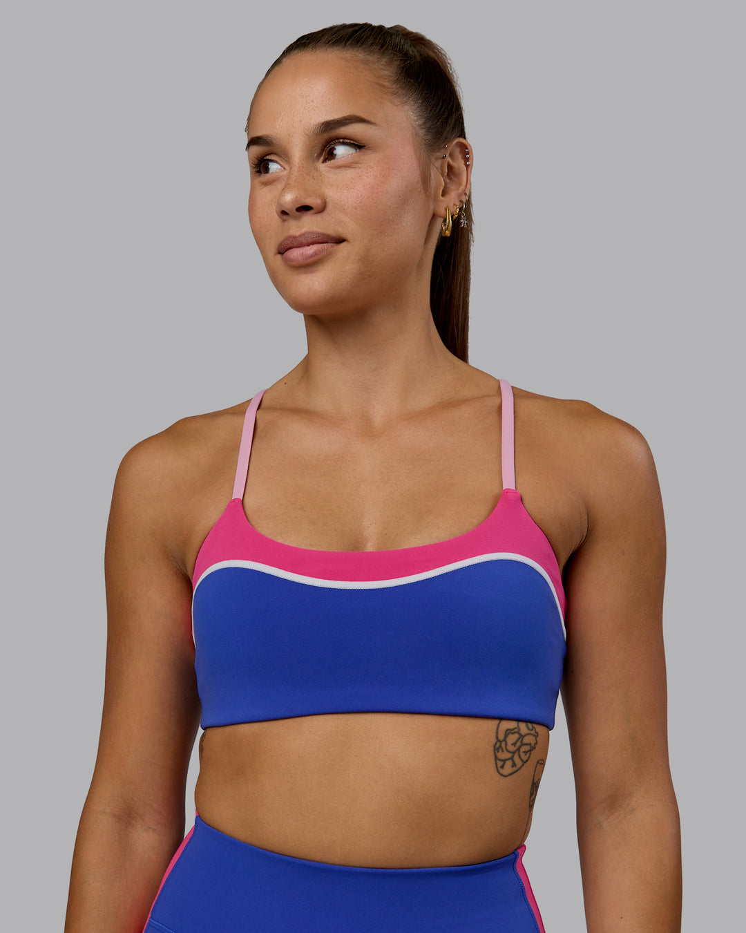 Woman wearing Embrace Sports Bra - Power Cobalt-Fuchsia Pink