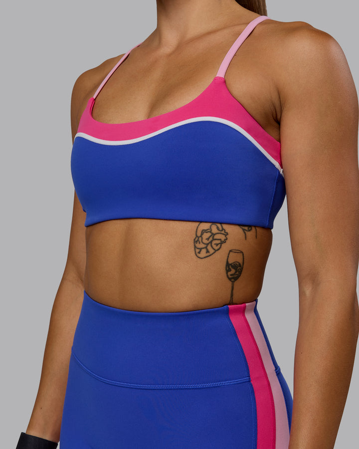 Woman wearing Embrace Sports Bra - Power Cobalt-Fuchsia Pink
