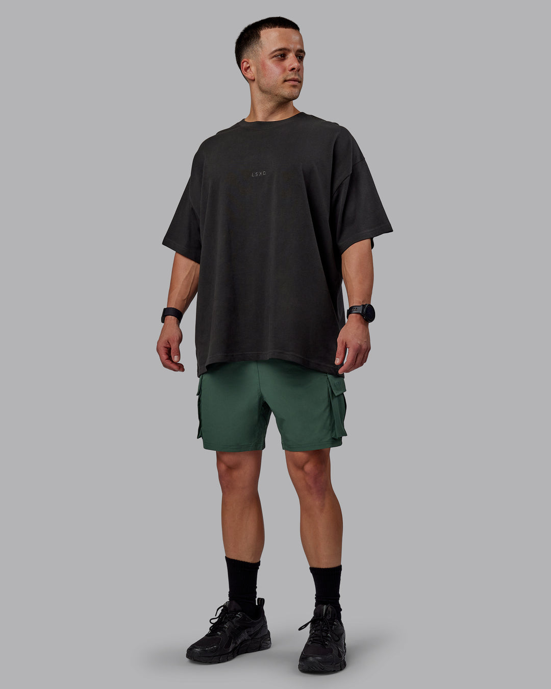 Man wearing Energy Stretch Performance Cargo Shorts - Cilantro