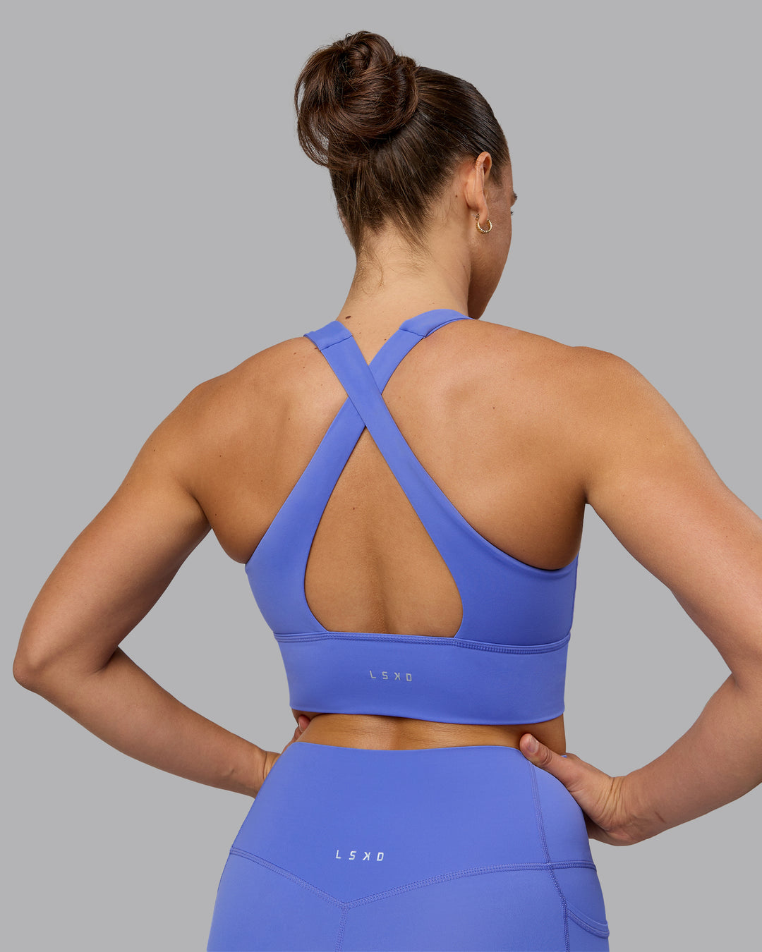 Woman wearing Evoke Sports Bra - Baja Blue