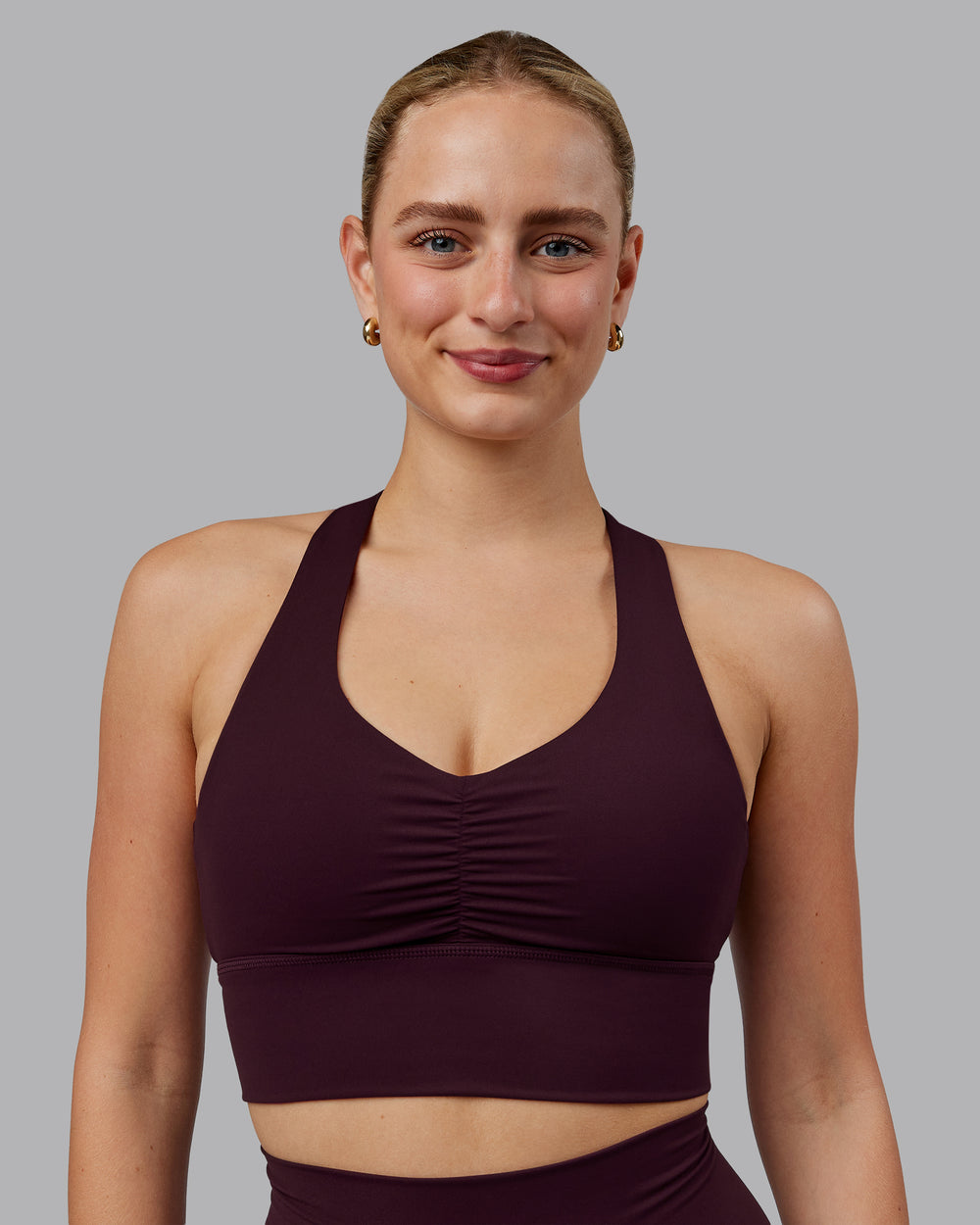 Woman wearing Evoke Sports Bra - Mulberry