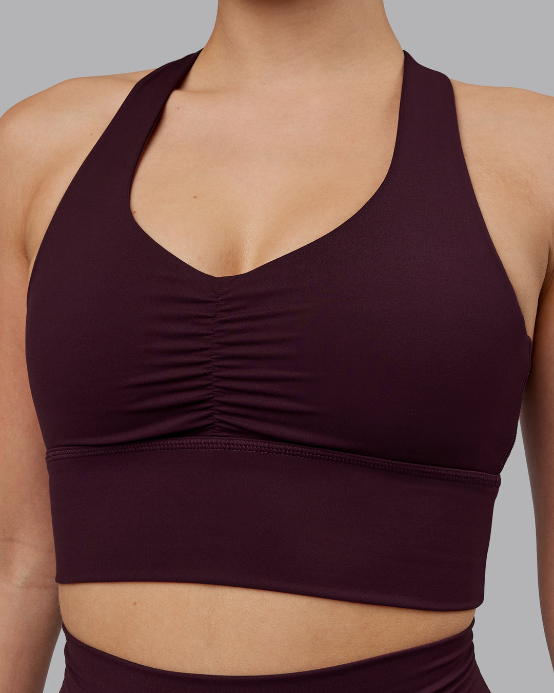 Woman wearing Evoke Sports Bra - Mulberry