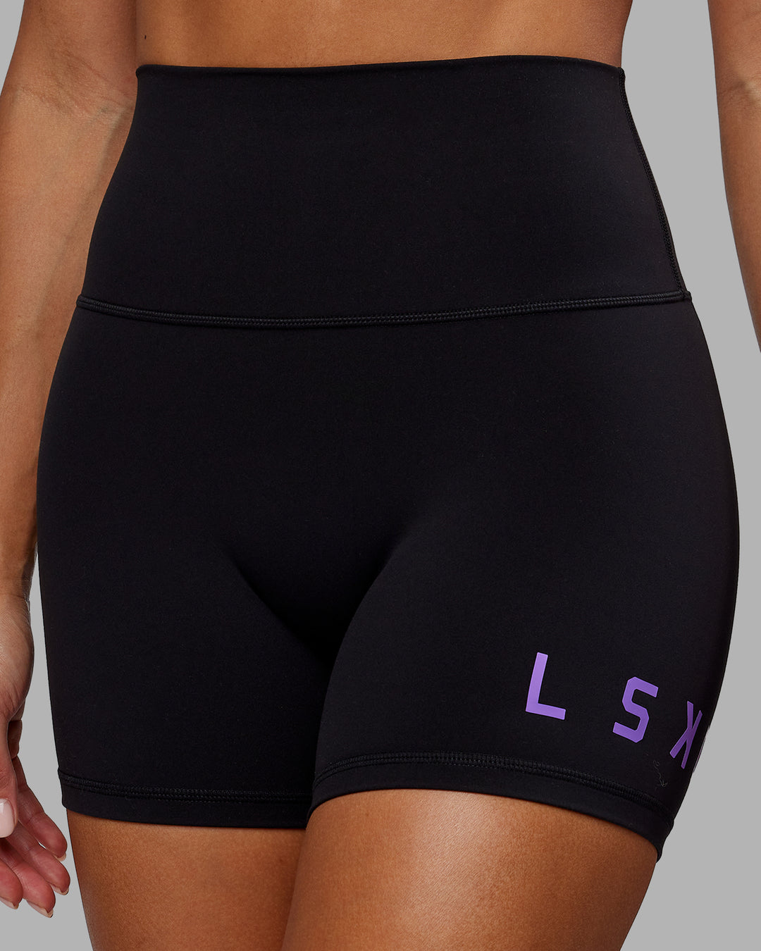 Woman wearing Evolved X-Short Tights - Black-Purple Swirl