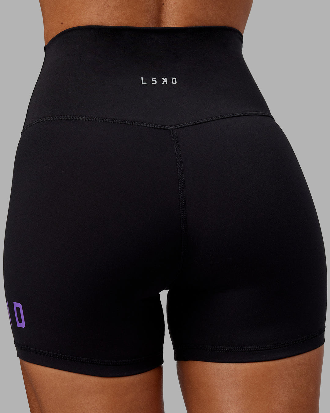 Woman wearing Evolved X-Short Tights - Black-Purple Swirl