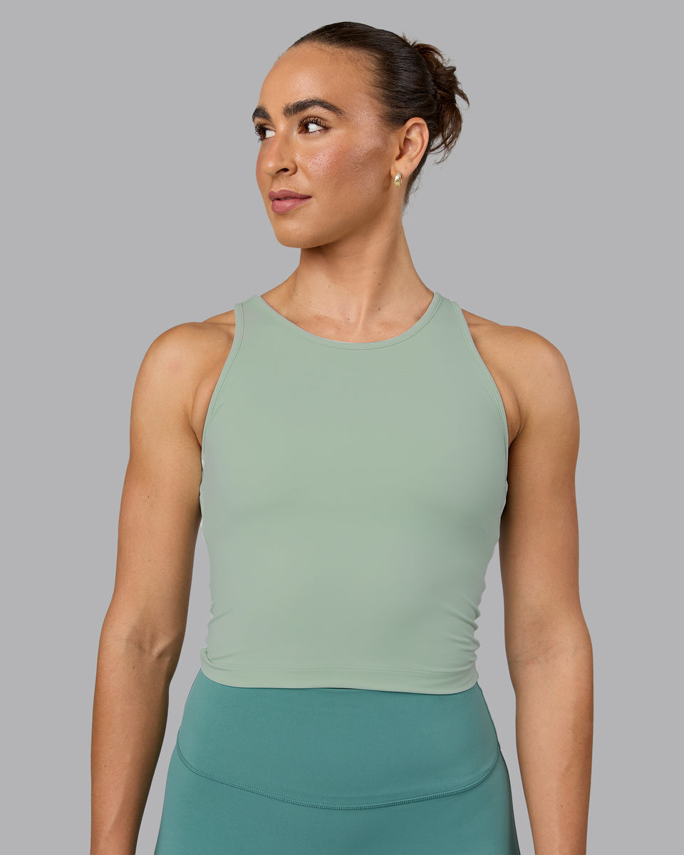 Woman wearing Flow Shelf Bra Performance Tank - Surf Spray