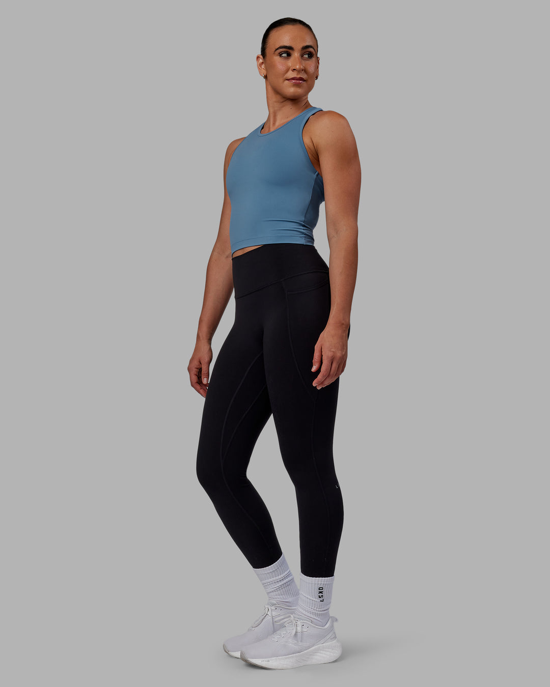 Woman wearing Flow Performance Tank - Elemental Blue