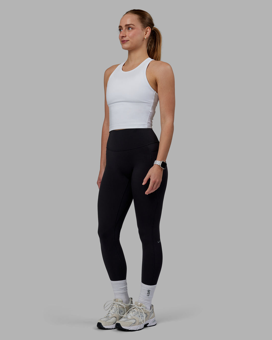 Woman wearing Flow Performance Tank - White