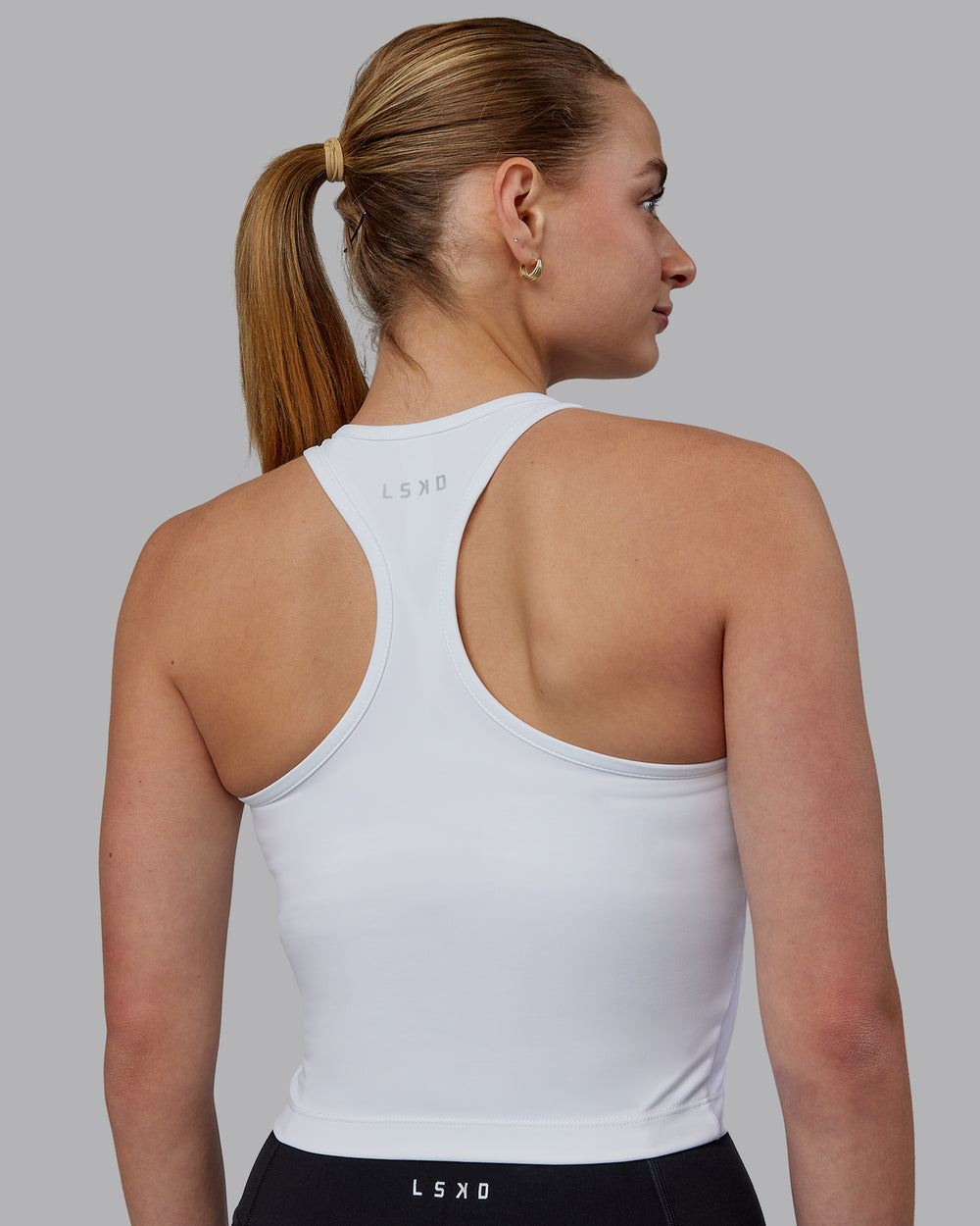 Woman wearing Flow Performance Tank - White