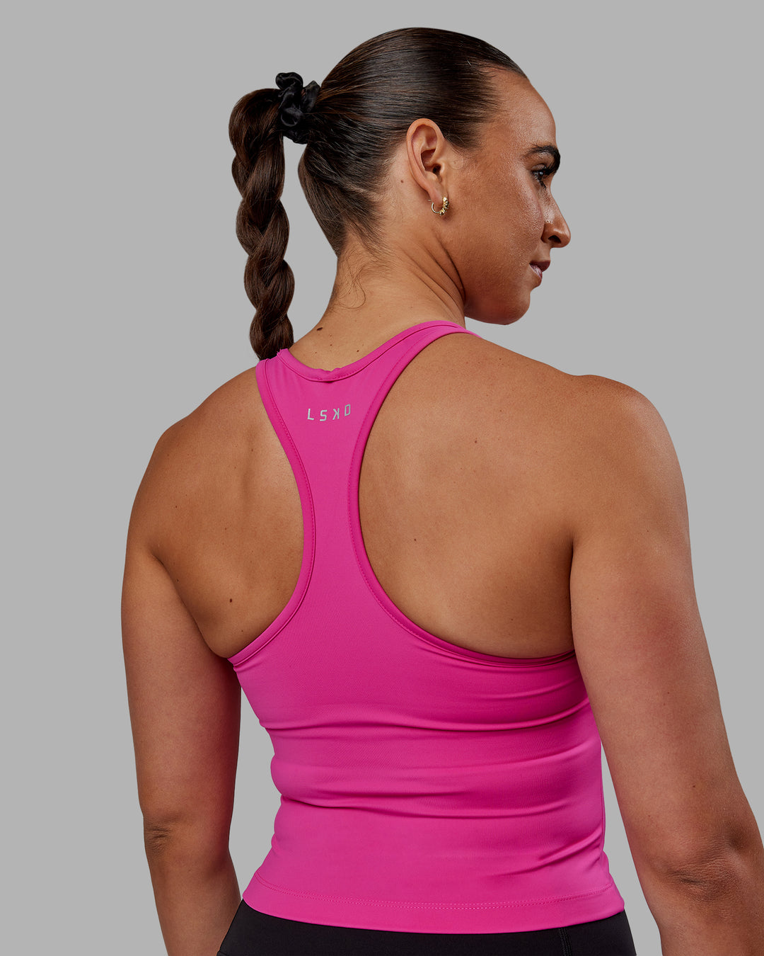 Woman wearing Flow Shelf Bra Performance Tank - Fuchsia Pink