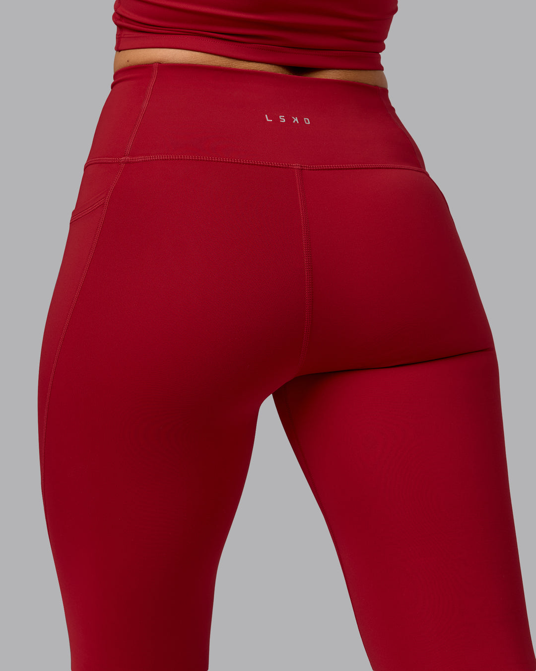 Woman wearing Fusion Full Length Tights with Pockets - Cherry Red