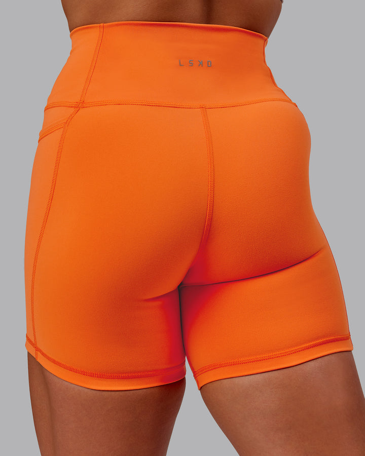 Woman wearing Fusion Mid Short Tights with Pockets - Mandarin
