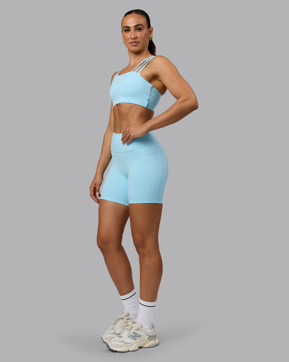 Woman wearing Fusion Mid Short Tights with Pockets - Crystal Blue