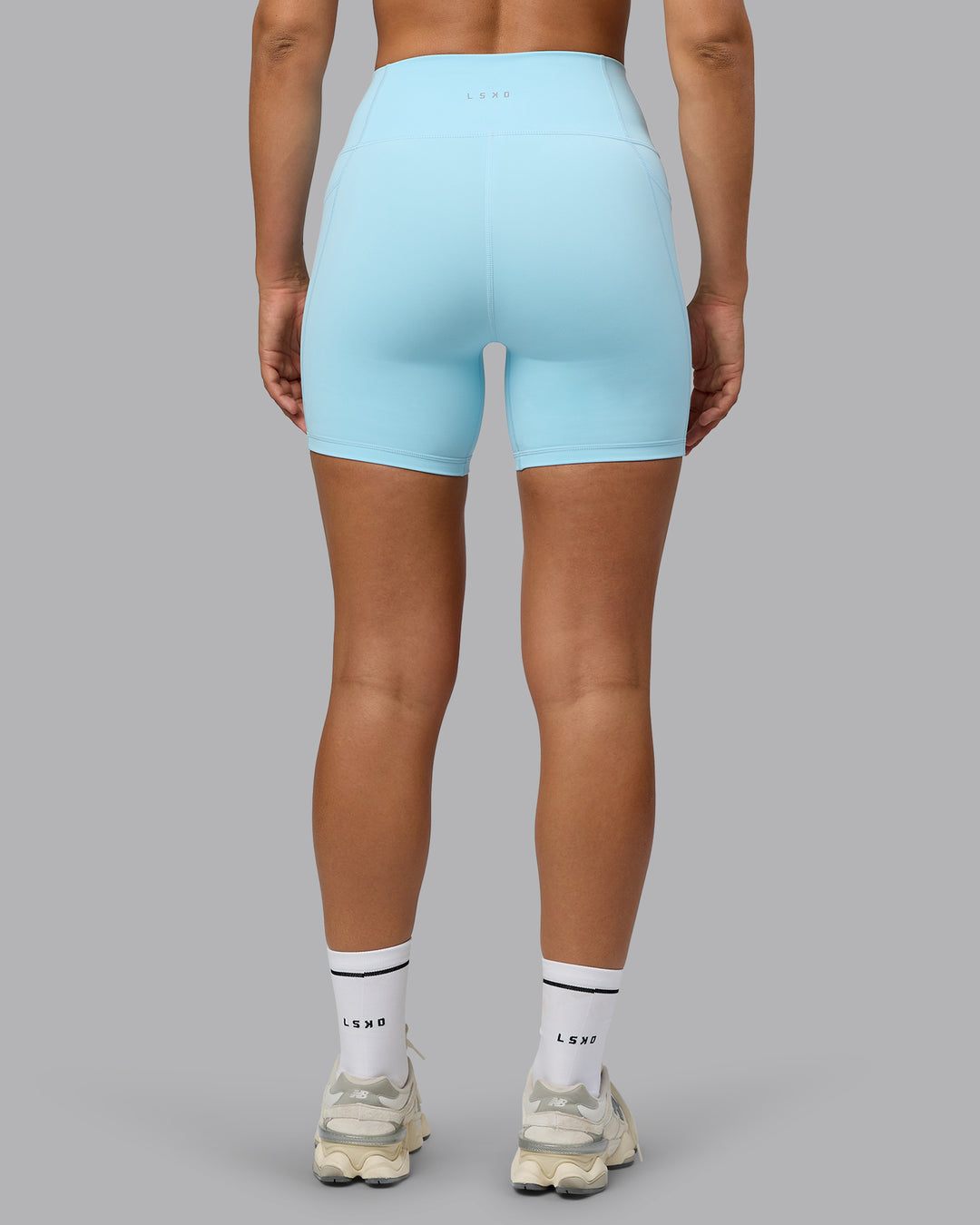 Woman wearing Fusion Mid Short Tights with Pockets - Crystal Blue