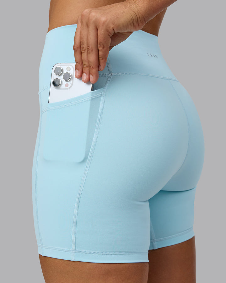 Woman wearing Fusion Mid Short Tights with Pockets - Crystal Blue
