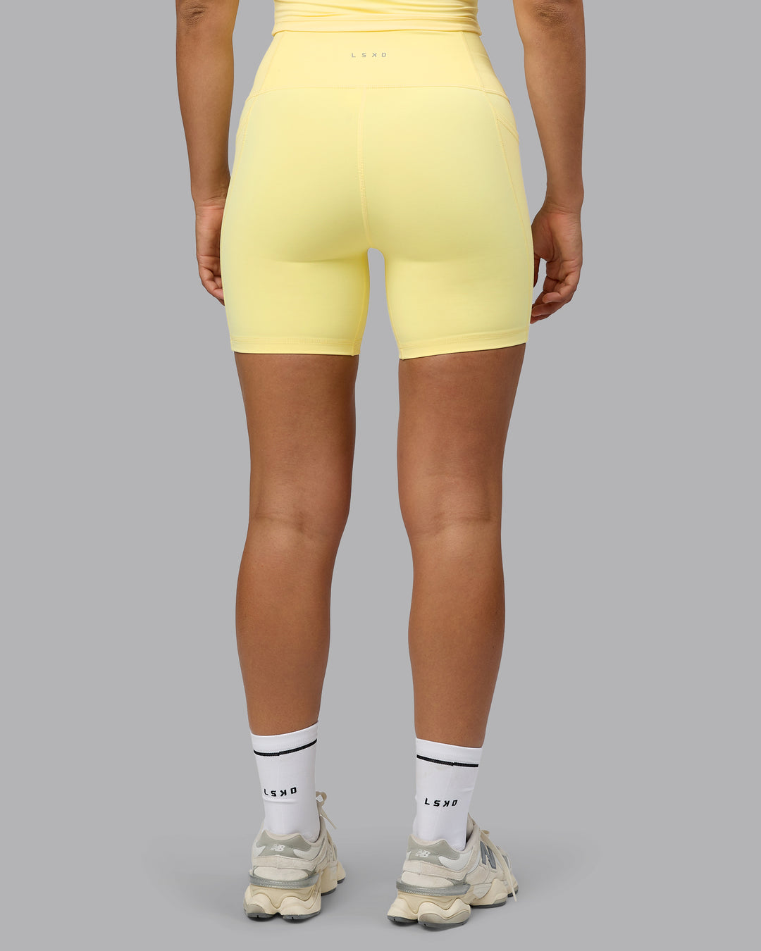 Woman wearing Fusion Mid Short Tights with Pockets - Lemon